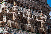 Bangkok Wat Arun - Statues of the mythical  demon bears  that support the different levels of the prang.